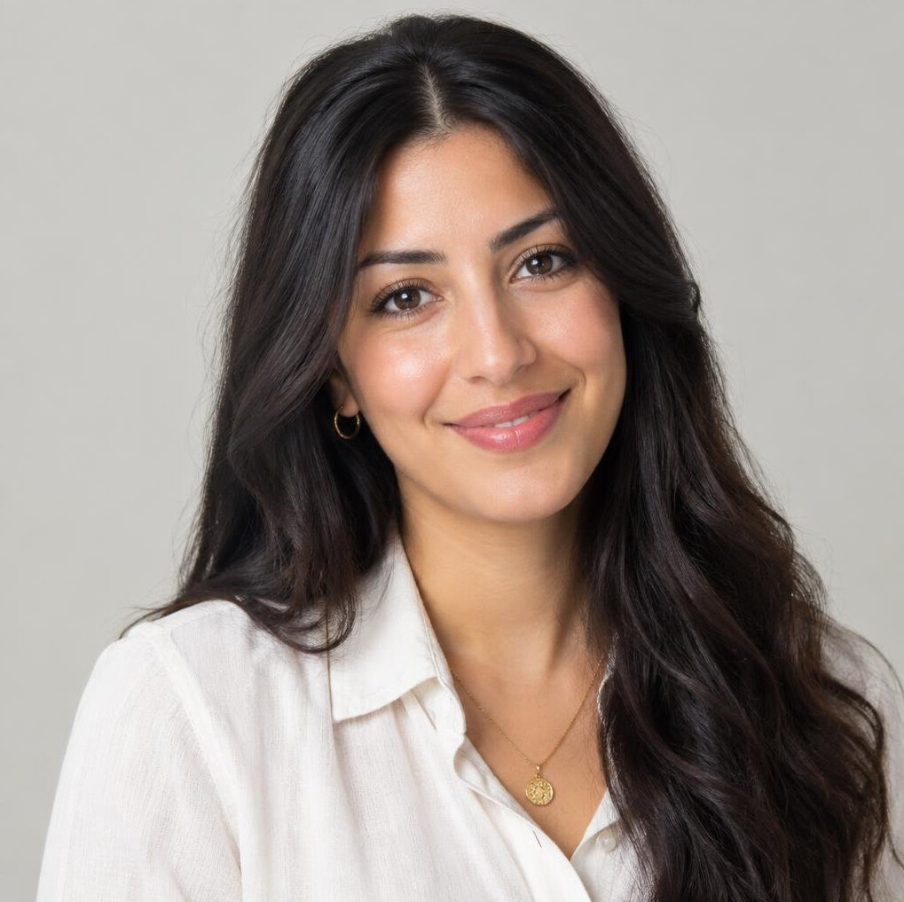 Portrait of a young woman with long dark hair smiling